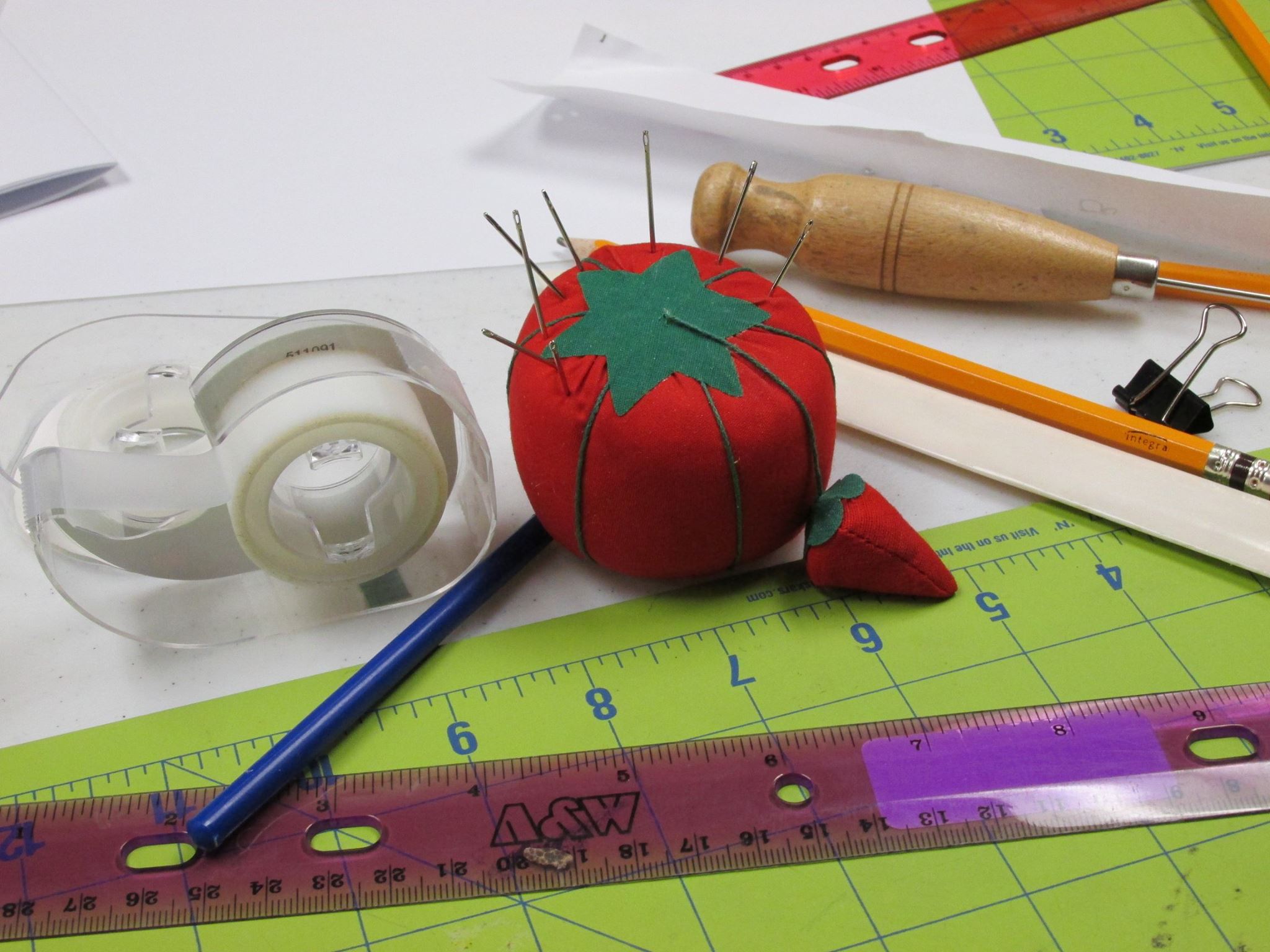 pincushion, ruler, tape and assorted crafting tools