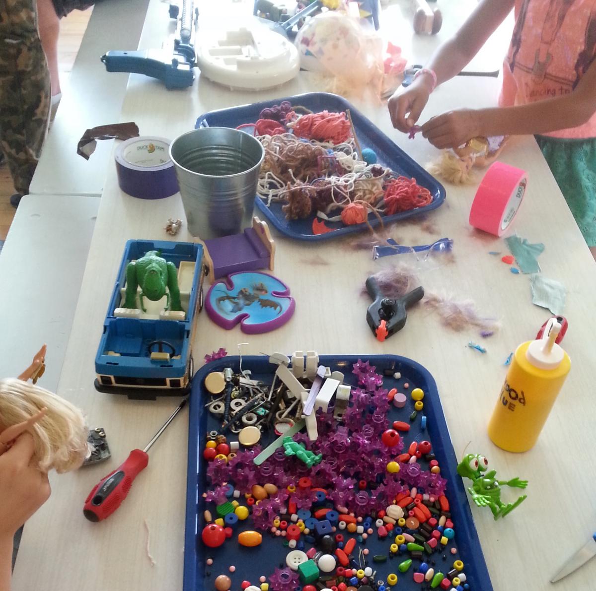 Kids making frankentoys from miscellaneous materials