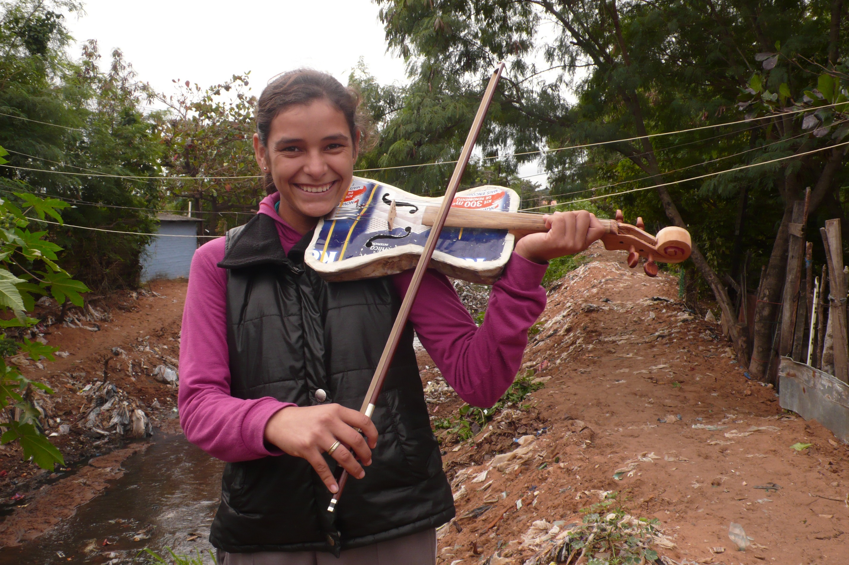 Girl from the Recycled Orchestra poses with her violin